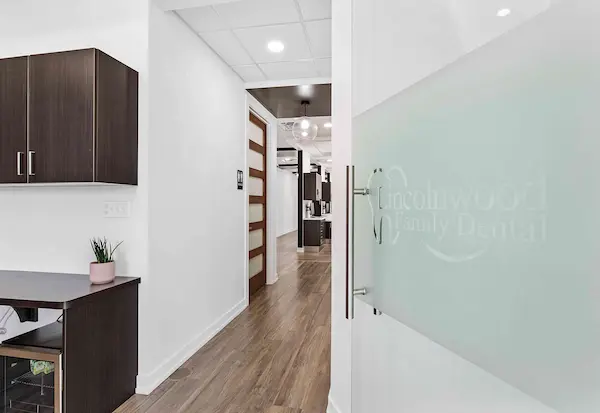 Clinical entrance through a beautiful glass door with a Lincolnwood Family Dental Logo.